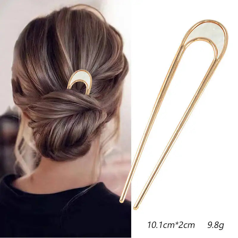 Colette Nacre shell-inlay gold French hair pin in a chignon