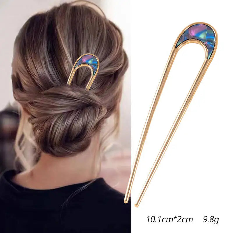 Colette Nacre shell-inlay gold French hair pin in a chignon