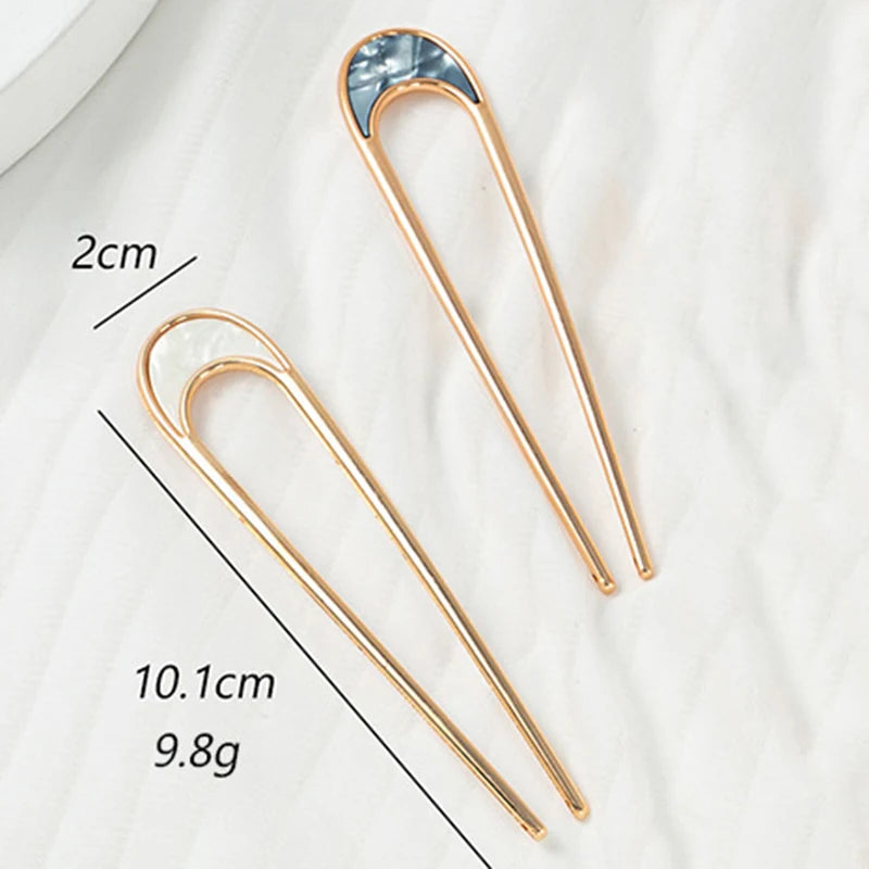 Colette Nacre shell-inlay gold French hair pin in a chignon