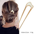 Colette Nacre shell-inlay gold French hair pin in a chignon