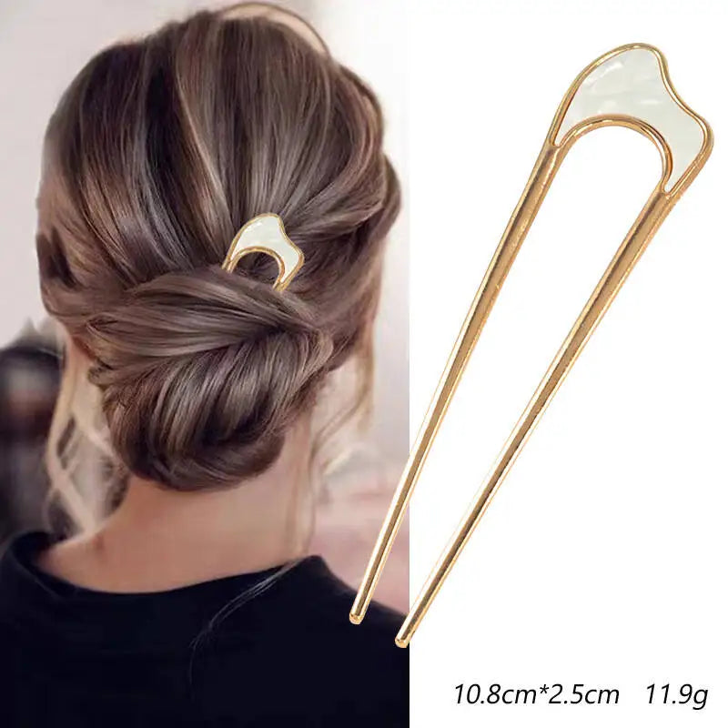 Colette Nacre shell-inlay gold French hair pin in a chignon