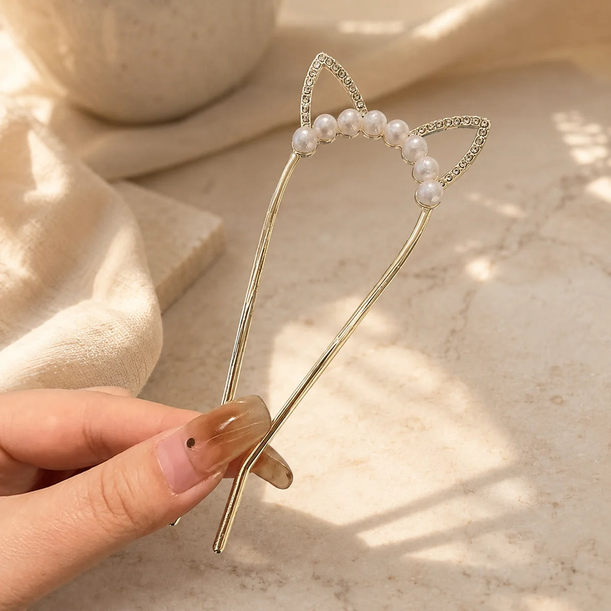 Colette Perle pearl-topped French hair pin in a chignon