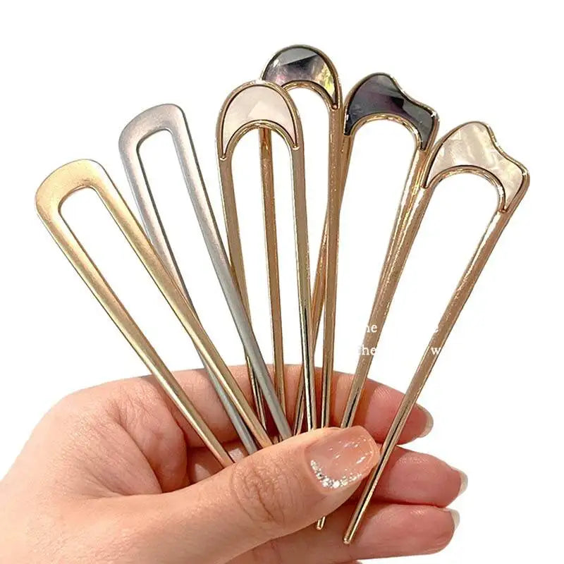 Colette Nacre shell-inlay gold French hair pin in a chignon
