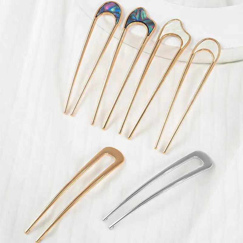 Colette Nacre shell-inlay gold French hair pin in a chignon