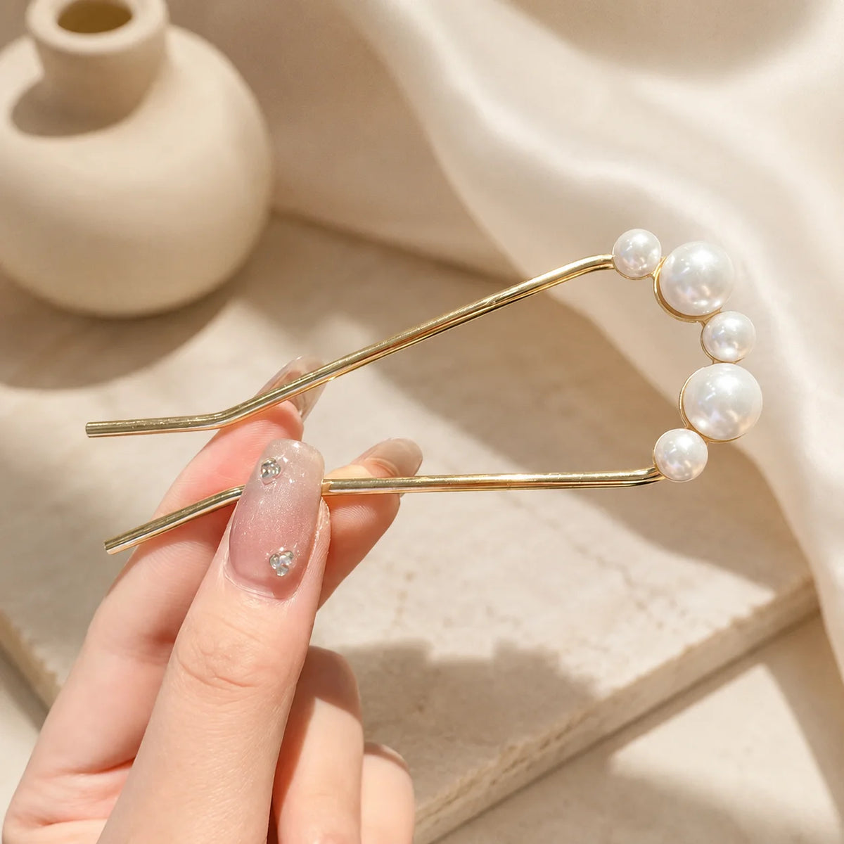 Colette Perle pearl-topped French hair pin in a chignon