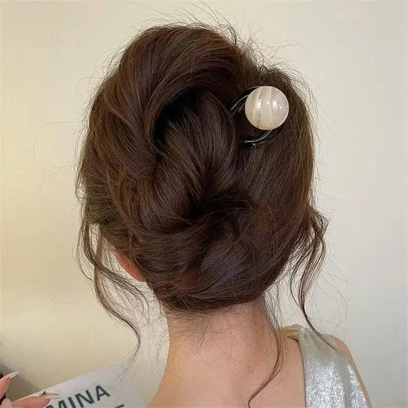 Colette Bonbon tortoise hair pin with glass bead in a low bun