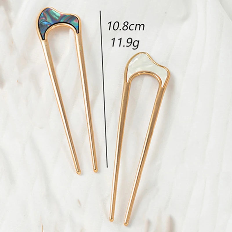 Colette Nacre shell-inlay gold French hair pin in a chignon