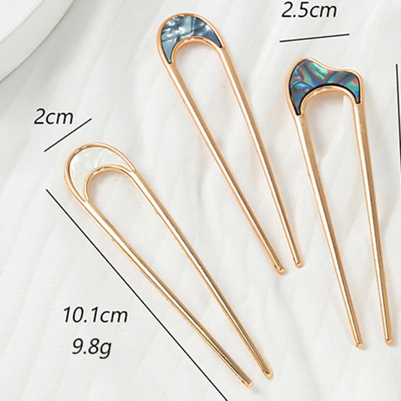 Colette Nacre shell-inlay gold French hair pin in a chignon