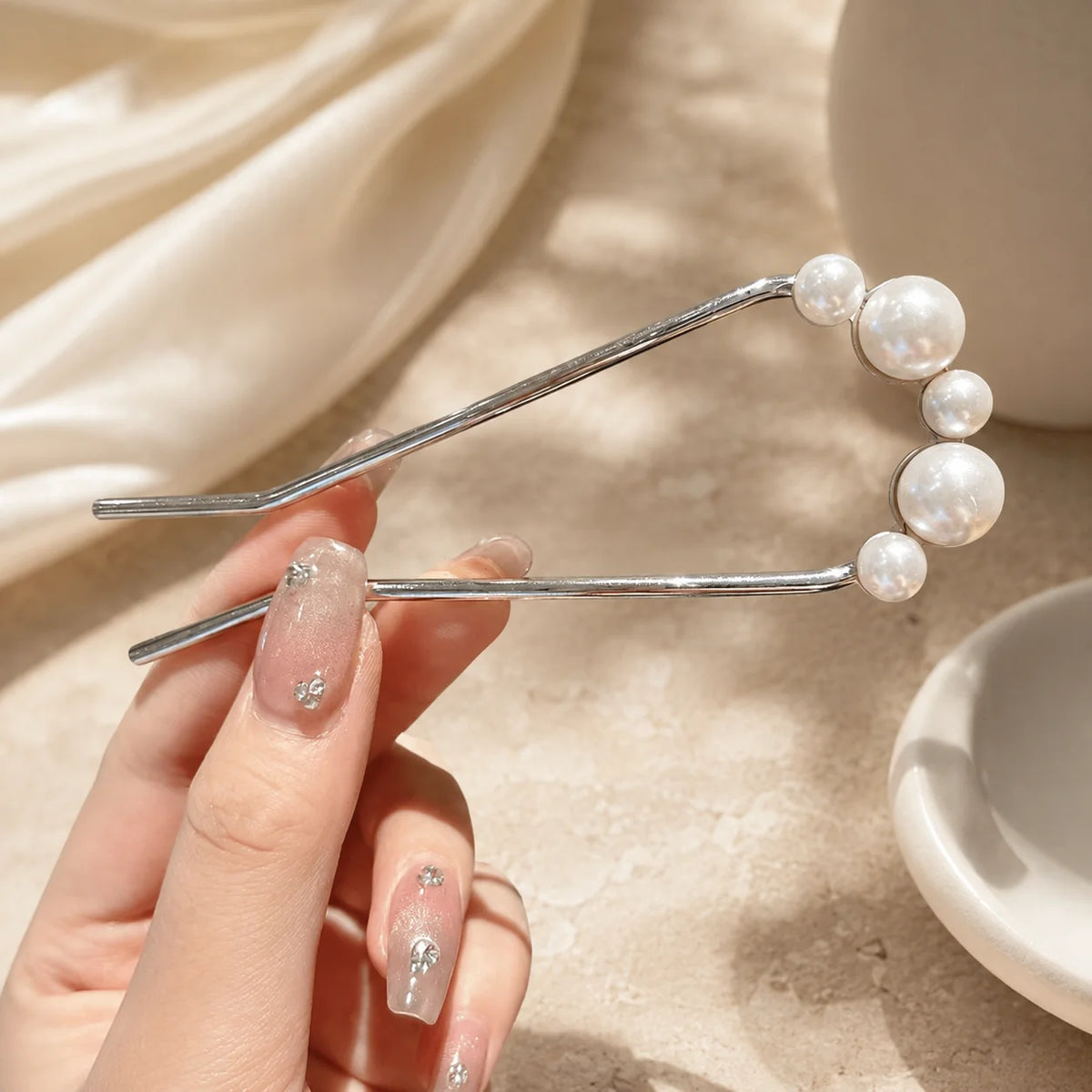 Colette Perle pearl-topped French hair pin in a chignon