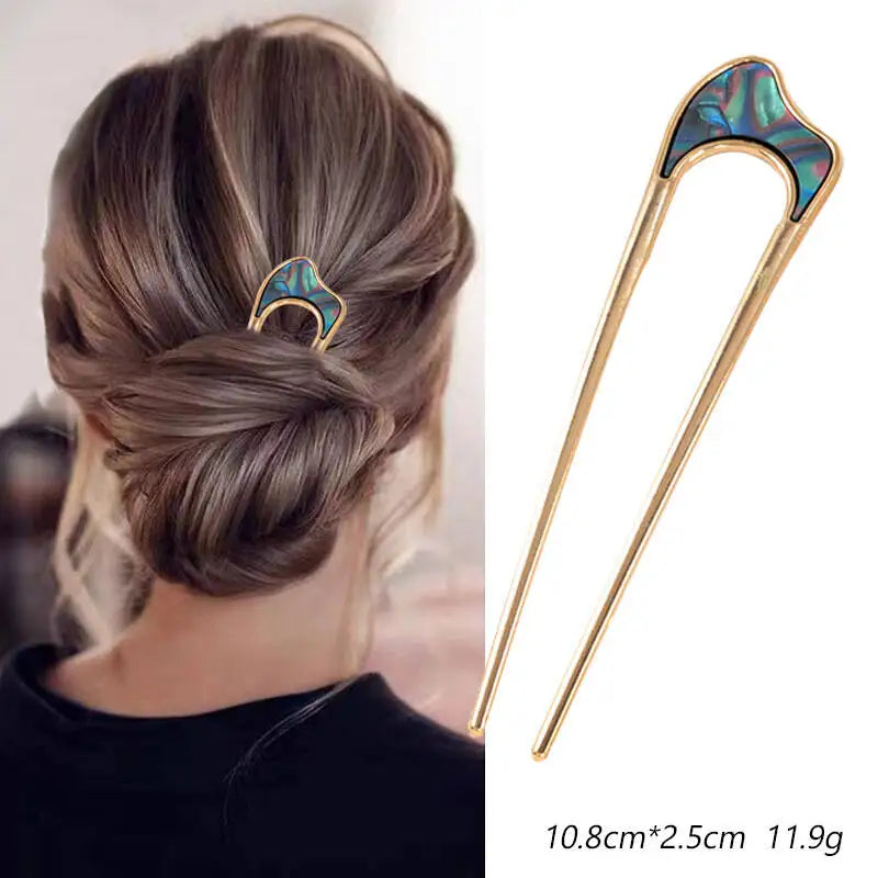 Colette Nacre shell-inlay gold French hair pin in a chignon