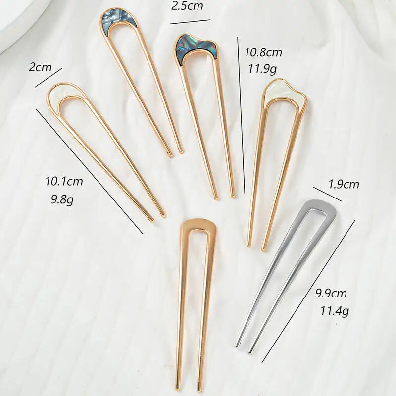 Colette Nacre shell-inlay gold French hair pin in a chignon