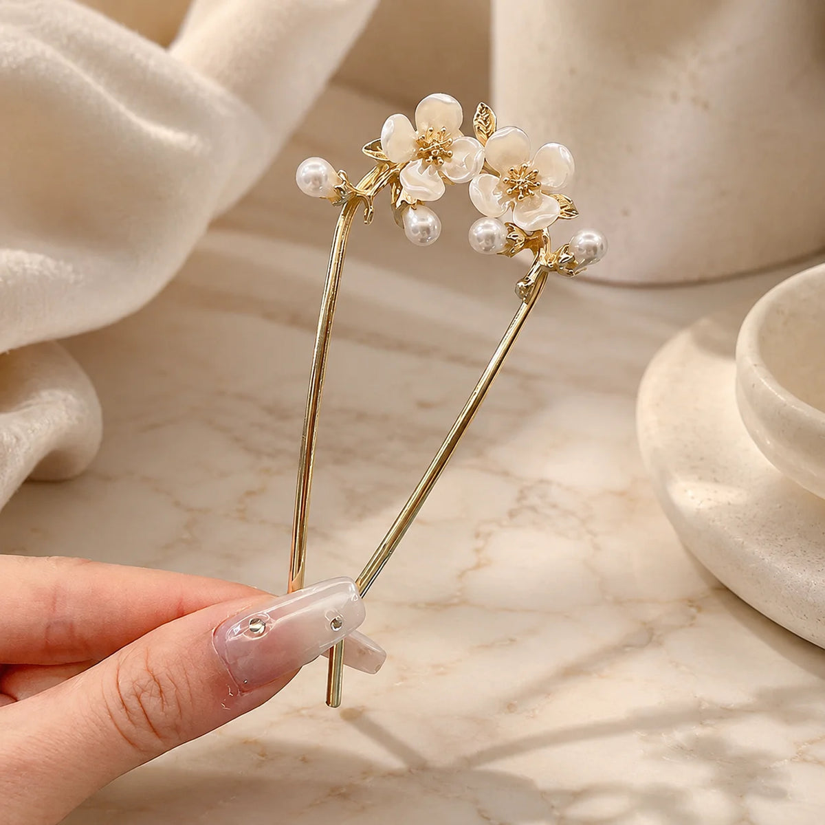 Colette Perle pearl-topped French hair pin in a chignon