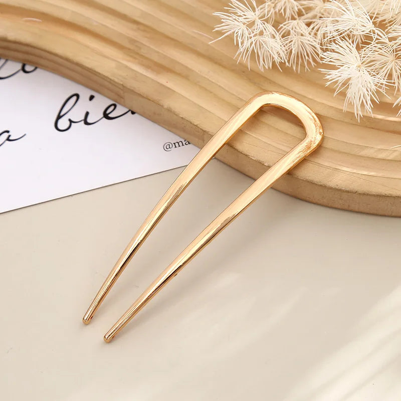 Colette Minimal slim metal hair pin in a bun