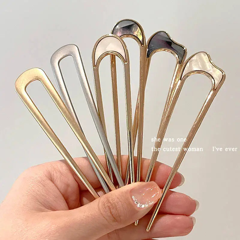 Colette Nacre shell-inlay gold French hair pin in a chignon