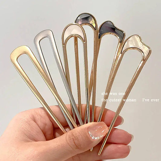 Colette Nacre shell-inlay gold French hair pin in a chignon