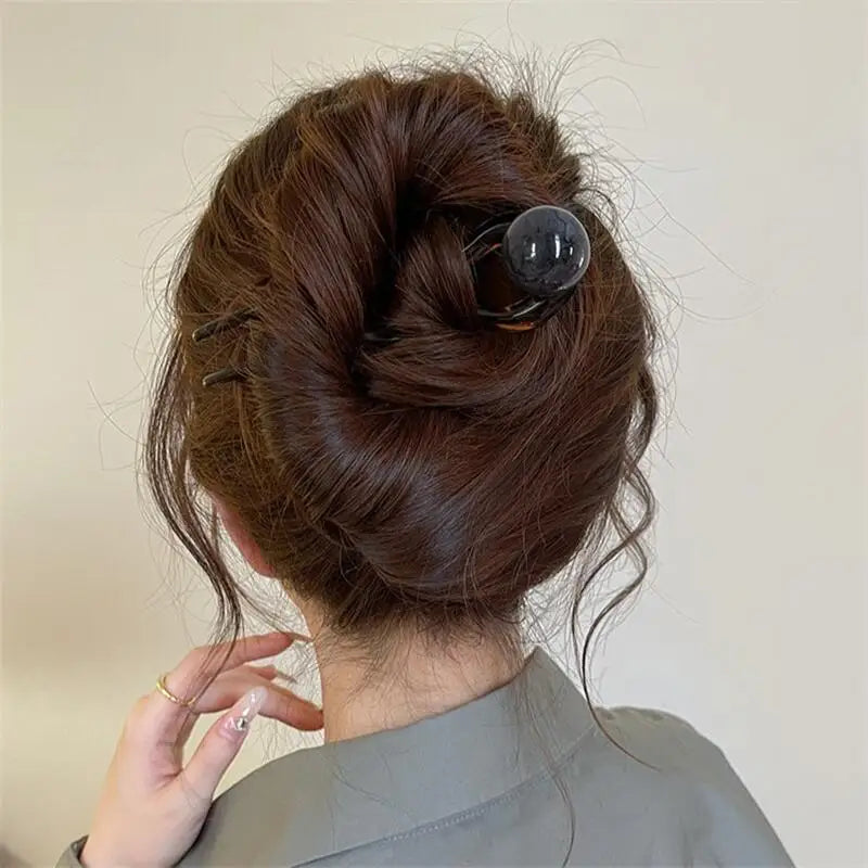 Colette Bonbon tortoise hair pin with glass bead in a low bun