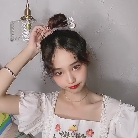 Colette French hair pin sliding into a bun